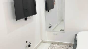 Luxury Apartment, City View | In-room safe, desk, laptop workspace, iron/ironing board