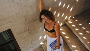 A person standing on a staircase with a book, in a building with a concrete wall and a window. - Casa Ampa Zikatela - Brisas de Zicatela- Puerto Escondido (Brisas de Zicatela)