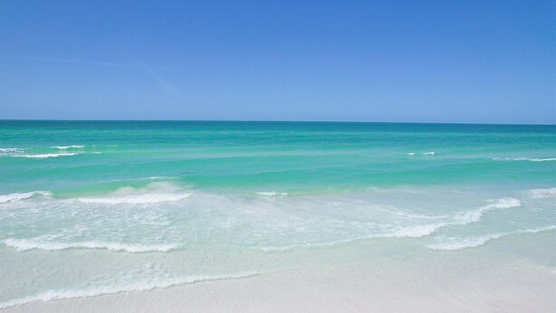 A beach with clear turquoise water and white sand. - Venice Beach Two Bedroom Private Condo with Community Pool, Gulf Beach Access and Water Views! (Venice)