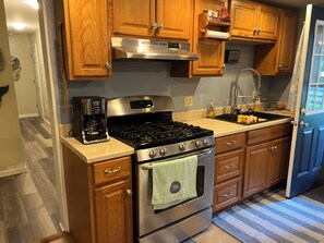 Fridge, microwave, stovetop, coffee/tea maker