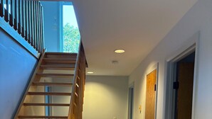 Una escalera con barandillas de madera que da a un rellano.