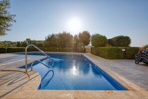 A swimming pool with a metal ladder, surrounded by a paved area and well-maintained hedges. - The Dreamy Terrace Pool BBQ in Xag ra Gozo (Xaghra)