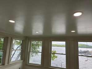 Ein Zimmer mit Seeblick, einer Decke mit Einbaustrahlern und einem Fenster mit Blick auf Boote.