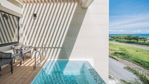 A modern outdoor pool area with a view of the road and greenery. - CELEVI NANJO (Nanjo)