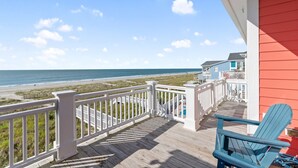 A wooden deck with a white railing, overlooking a beach and ocean. - "Coral Relief" 6 Bedroom, 6.5 Bathrooms, Private Pool and Elevator! (Supply)