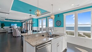 A modern kitchen with a large island, stainless steel appliances, and a view of the ocean. - "Coral Relief" 6 Bedroom, 6.5 Bathrooms, Private Pool and Elevator! (Supply)