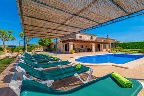 A poolside area with lounge chairs and a swimming pool.