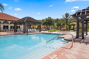 A swimming pool with lounge chairs and a gazebo. - Upstay Lakefront Home w Pool Cinema Games BBQ (Kissimmee)