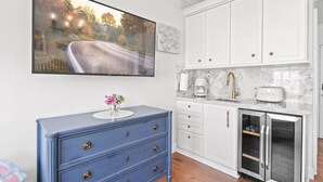 A kitchen with white cabinets, a blue dresser, a marble countertop, and a built-in refrigerator. - Condo Studio/Pool/StepsTO Beach/DINE (Palm Beach)