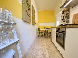 A kitchen with a dining table, chairs, and a stove.