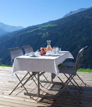 A table set outdoors with a mountain view.