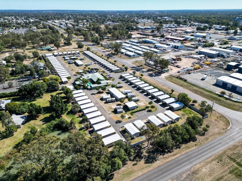 An aerial view of a large industrial area with multiple warehouse buildings and a parking lot.