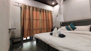 A hotel room with a bed, a bedside table, a curtain, and a hanging white canopy. - Dokchampa River View Villa (Nong Khiaw)