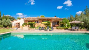 A house with a swimming pool, outdoor seating, and a clear blue sky. - SON GARRETA - Beautiful country house with private pool and free wifi (Campanet)