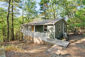 A small cabin with a porch, surrounded by trees. - Cozy cabin w/ Screened porch & BBQ (Hedgesville)