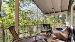 A covered porch with wicker furniture, a sofa, and a table. - Cozy cabin w/ Screened porch & BBQ (Hedgesville)