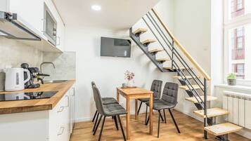 Een koelkast, een magnetron, kookgerei, borden en bestek