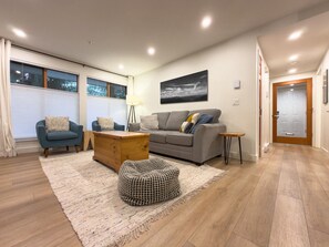 A modern living room with a sofa, armchairs, a coffee table, and a rug. - Stoney Creek Northstar 109 (Whistler)