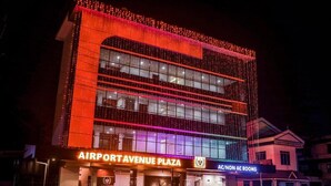 A multi-story building with a sign reading "AIRPORT AVENUE PLAZA" and "AC/NON AC ROOMS". - Airport Avenue Plaza (Nedumbassery)