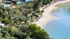 A coastal resort with a beach, swimming pools, and lush greenery. - Grecotel Eva Palace (Limni)