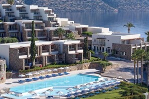 A resort with a swimming pool, multiple balconies, and a view of the sea. - Wyndham Grand Crete Mirabello Bay (Agios Nikolaos)