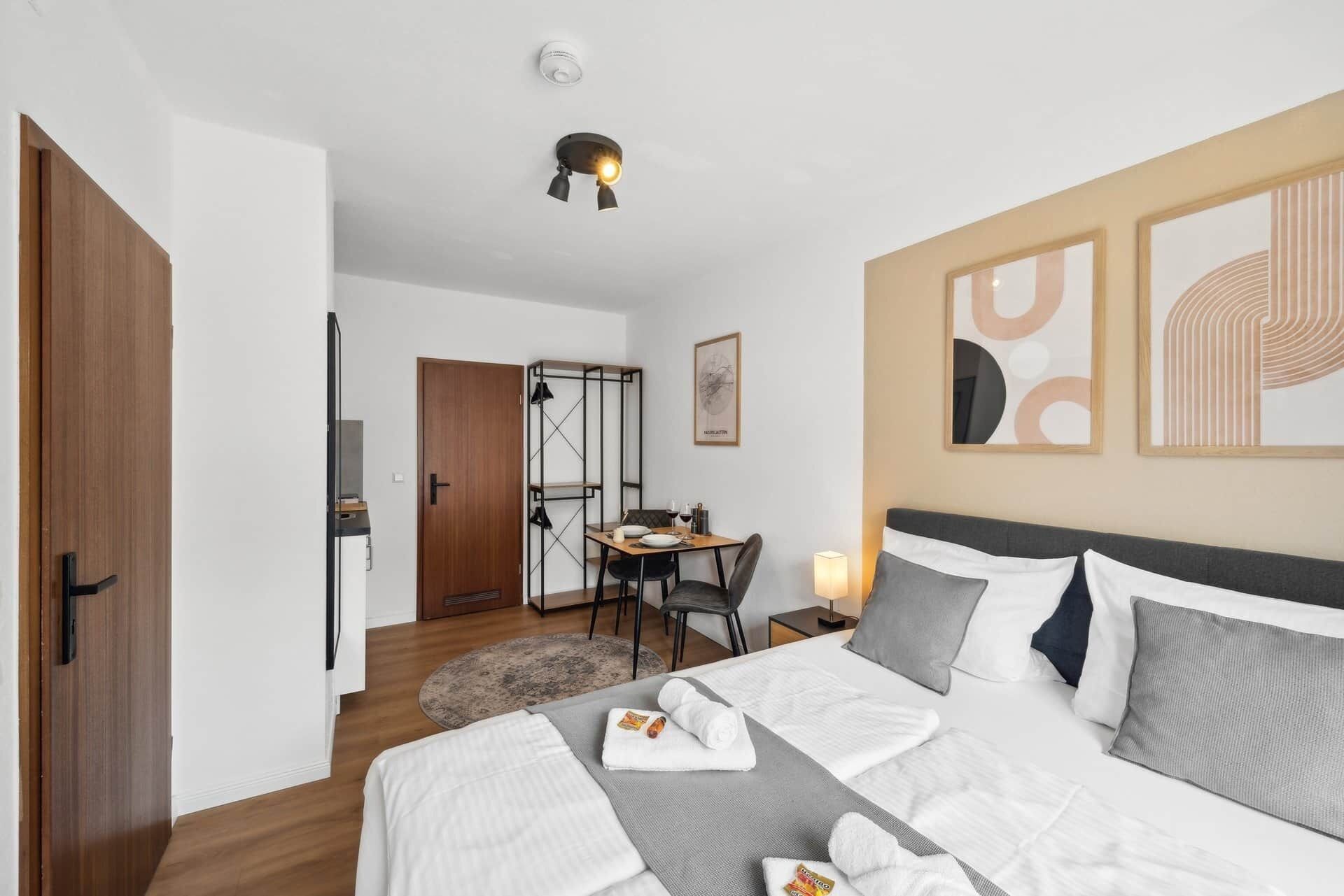 Ein modernes Hotelzimmer mit Bett, Schreibtisch und Essecke.