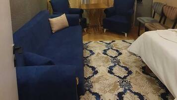 Deluxe Apartment, Sea View | Living area | TV