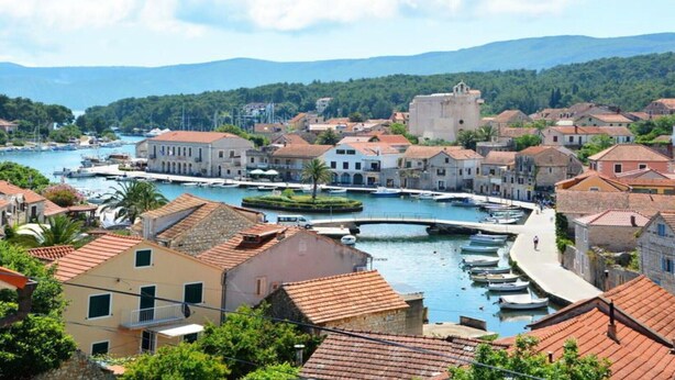 A coastal town with a marina, historic buildings, and a prominent tower. - One Bedroom Apartment with Balcony and Sea View 2 (Vrboska)