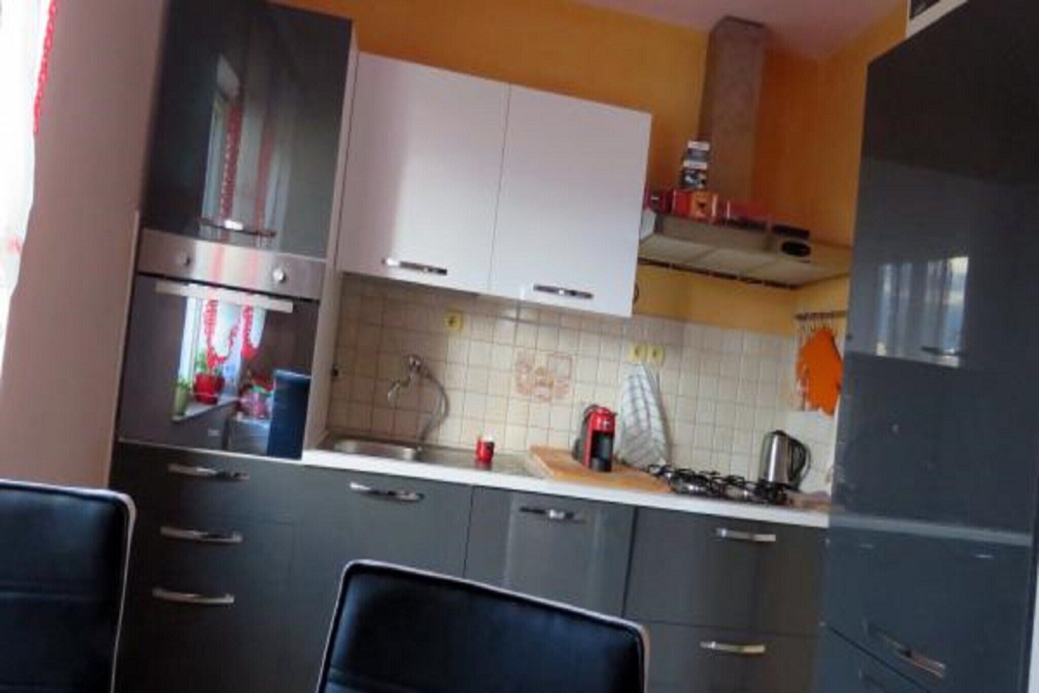 A kitchen with a gas stove, oven, and cabinets.