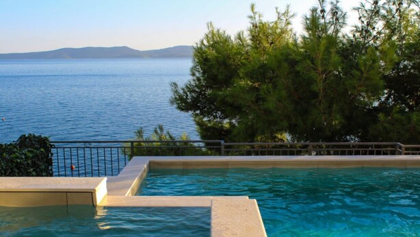 A swimming pool with a view of the sea and mountains. - Two Bedroom Apartment with Sea View and Private Pool (Pisak)