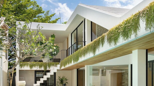 A modern house with a swimming pool, outdoor seating, and a staircase leading to an upper level. - Kona Resort - Seminyak (Denpasar)