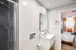 Shower, hair dryer, towels, toilet paper