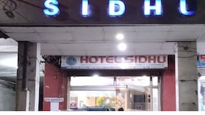 A hotel sign with the name 'HOTEL SIDHU' in bright red and blue letters. - HOTEL SIDHU  (Jamshedpur)