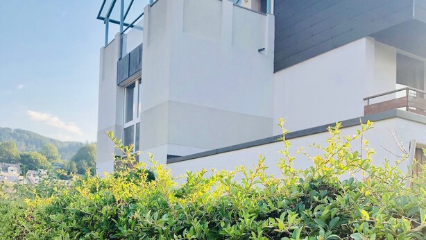 A modern building with a glass structure on the roof, a white facade, and a balcony. - Guest Room Koch with Panoramic View, Private Terrace and Wi-Fi (Bad Säckingen)