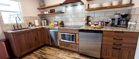A kitchen with wooden cabinets, a stainless steel dishwasher, a microwave, and a built-in oven.