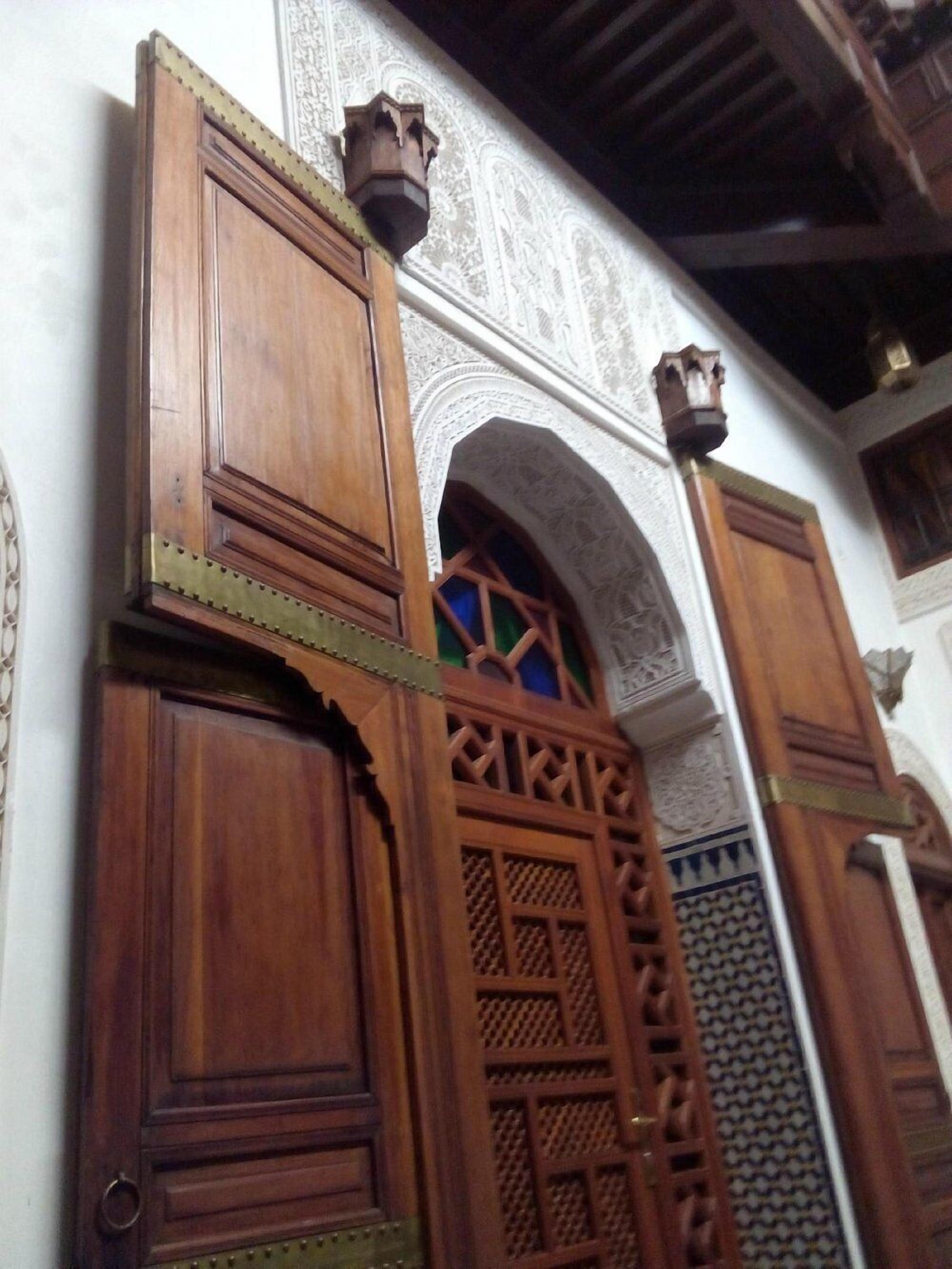 A wooden door with intricate carvings and a decorative archway.