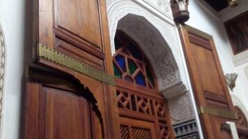 A wooden door with intricate carvings and a decorative archway.