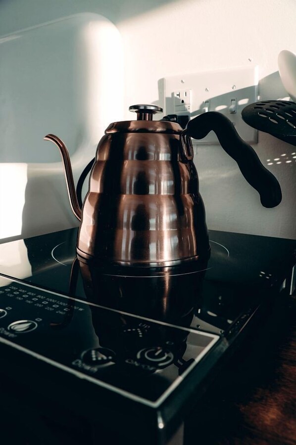 A copper kettle on an induction cooktop.