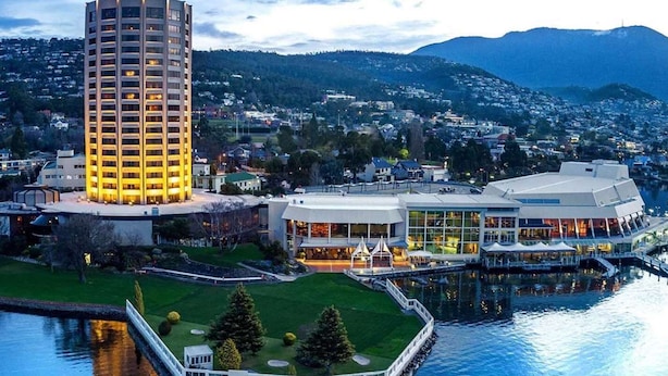 A high-rise hotel with multiple floors, a waterfront view, and a modern building complex with large windows and outdoor seating areas. - The View | Panoramic River Views | Sleeps 12 (Sandy Bay)