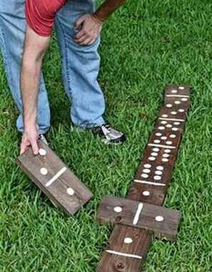 A wooden board game with pieces on a grassy surface. - The Gator Den at Caddo Lake in Karnack, Texas (Karnack)