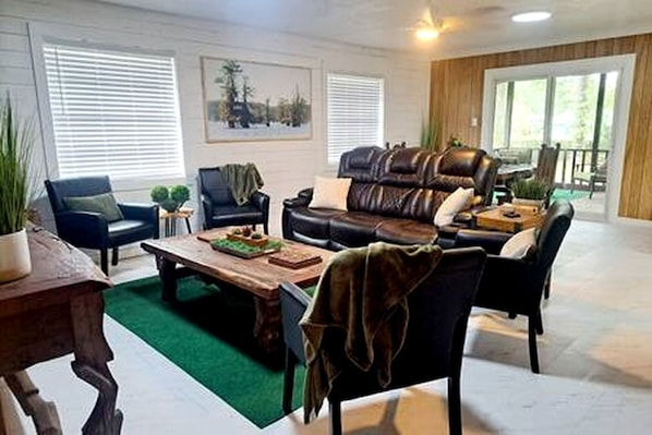 A living room with a sofa set, a coffee table, and a fireplace.
