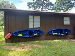 A building with two windows and two kayaks mounted on the side. - The Gator Den at Caddo Lake in Karnack, Texas (Karnack)