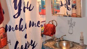 A bathroom with a shower curtain featuring colorful vehicles and the text 'You make me happy.' - Texas Hill Country Vintage Caravan Glamping (Marble Falls)