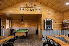 A billiards table, a pool table, and a sign reading 'Tappan Lakeside Resort' in a wooden room.