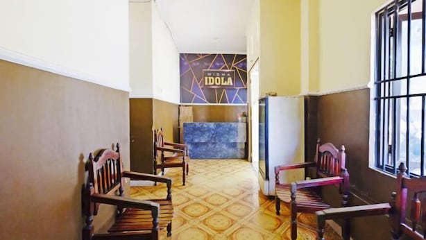 A hotel lobby with a reception desk, patterned floor, and wooden chairs. - Collection O Nagoya Near Nagoya Hill Mall Formerly Sedago Inn (Nagoya)