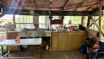 Coffee/tea maker, fridge, stovetop, cookware/dishes/utensils