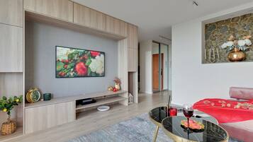 Departamento Deluxe, 1 habitación, vista al mar | Área de sala de estar | Televisión de pantalla plana