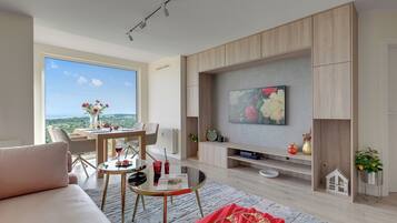 Departamento Deluxe, 1 habitación, vista al mar | Área de sala de estar | Televisión de pantalla plana