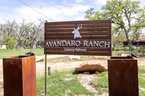 A sign for Avandaro Ranch Luxury Retreat with a deer silhouette.