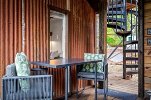 A wooden cabin with a balcony, a table with chairs, and a spiral staircase. - Beautiful Cabin with Fire Pit in Hayesville, North Carolina (Hayesville)
